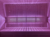 SaunaLife X7MOOD LED bar glowing soft pink over a cedar sauna bench