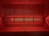 SaunaLife X7MOOD LED lighting casting deep red across a wood sauna