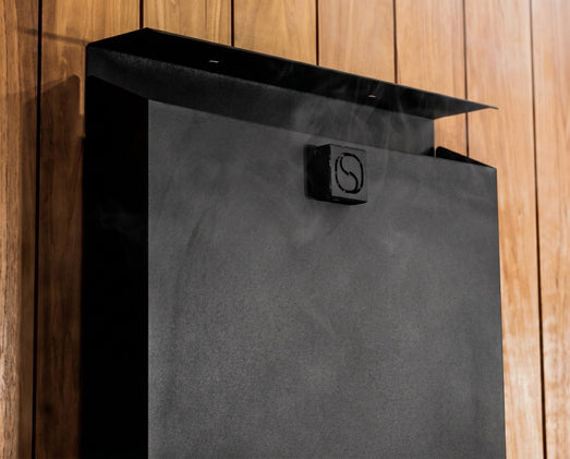 Detail of the Saunum Air 5 black equalizer column top with logo emblem and steam