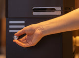 Hand adjusting the magnetic control knob on the Saunum Air 5 heater housing