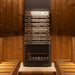 Saunum Air 5 heater between cedar benches against warm wood sauna walls, front view