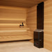 Saunum Air 5 heater in a light cedar sauna corner with black pail on the bench