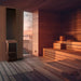 Saunum Air 5 heater in a cedar sauna with a large window framing a sunset view