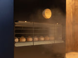 Steam rising over the Saunum Air 5 vent grille with a round wooden control knob