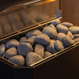 Close-up of rounded grey sauna stones filling the Saunum Air 5 heater basket