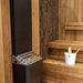 Saunum Air heater against a textured wood wall with a white bucket on the bench