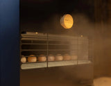 Close-up of the Saunum Air L 10 heater vent grille releasing steam with a wood knob
