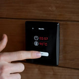 Wall control panel for the Saunum Air L 13 heater displaying Nordic mode, 02:57 timer and 90C