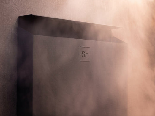 Detail of the Saunum Air L 15 black equalizer column top with embossed logo and steam