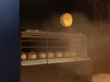 Close-up of the Saunum Air L climate equalizer vent with steam and wood control knob