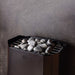 Close view of the Saunum Air Perfect heater top stone tray filled with stones