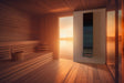 Saunum AirSolo 80 mounted in a warm-lit sauna at sunset over water