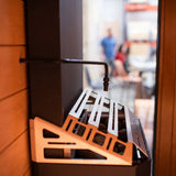 Saunum Auto Leil dispenser arm and bracket mounted to sauna heater side