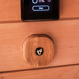 Saunum Auto Leil wooden wall button below a digital sauna touch controller