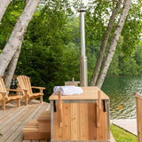 Dundalk Starlight wood burning hot tub on a deck beside chairs and a lake