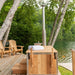 Dundalk Starlight wood burning hot tub on a deck beside chairs and a lake