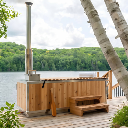 Dundalk Starlight wood burning hot tub on a lakeside dock framed by birch trees