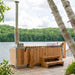Dundalk Starlight wood burning hot tub on a lakeside dock framed by birch trees