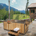 Dundalk Starlight wood burning hot tub on a stone patio with mountain backdrop