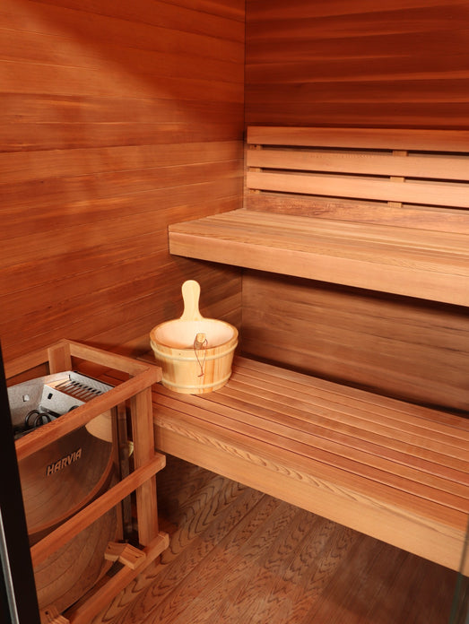 Harvia heater in a wooden guard inside the SunRay Cayman, with bucket and ladle