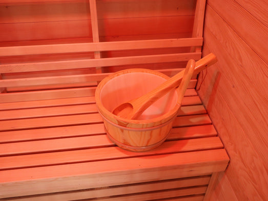 Wooden bucket and ladle on the bench of the SunRay Freeport sauna
