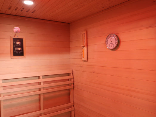 SunRay Freeport sauna interior corner with digital control panel, sand timer, round thermometer-hygrometer and backrest