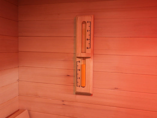 Wood-framed sand timer mounted on the wall of the SunRay Freeport sauna