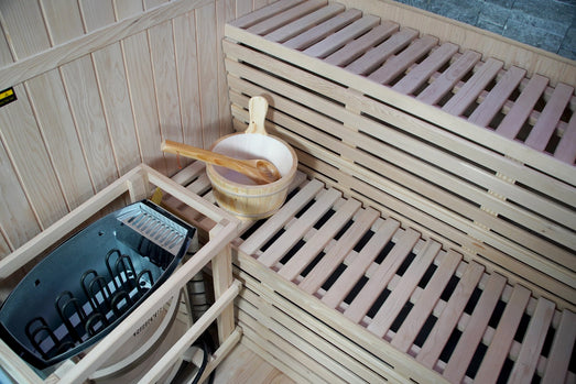 Harvia heater in its wooden guard inside the SunRay Galaxie, with bucket and ladle