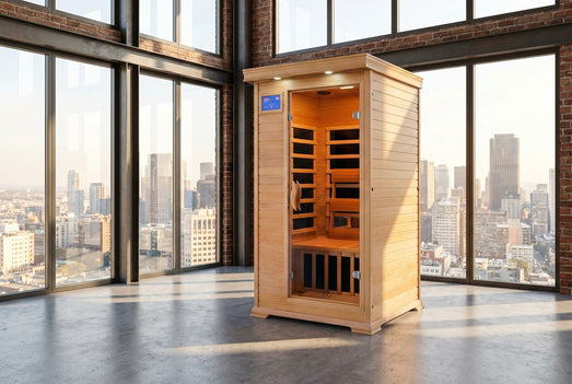 SunRay Sedona 1-2 person indoor infrared sauna in a loft with floor-to-ceiling city-view windows