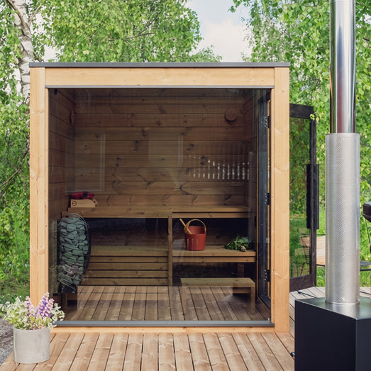 ThermaSol Nordic Dawn outdoor sauna cabin with open front, chimney and garden decking