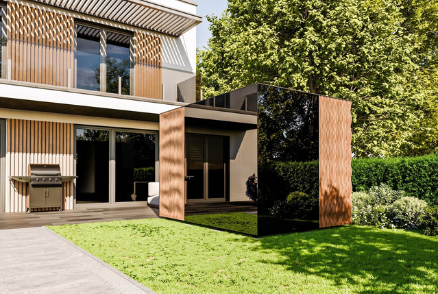 ThermaSol Ombra outdoor sauna cabin with bronze glass in a garden setting