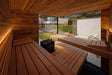 Warmly lit interior of the ThermaSol Ombra sauna cabin with cedar benches