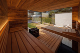 Warmly lit interior of the ThermaSol Ombra sauna cabin with cedar benches