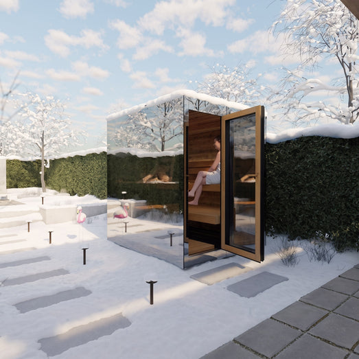 ThermaSol Vue mirrored sauna cabin in a snowy garden with the door open