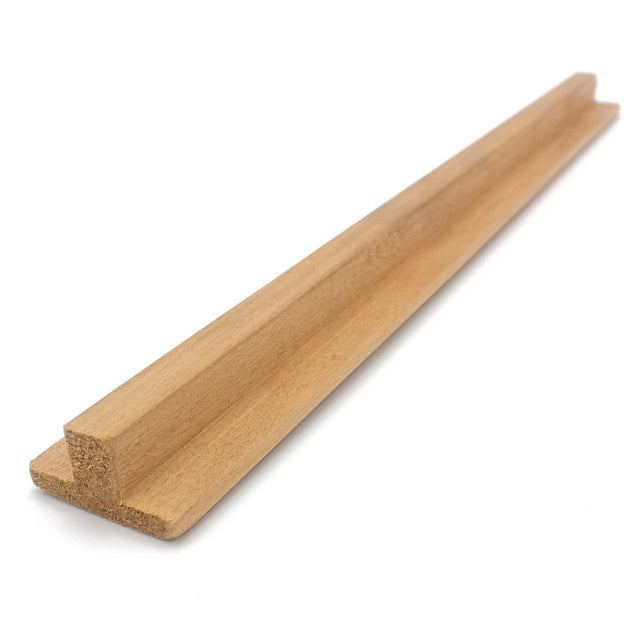 Thermo-Aspen 1x2 T-Molding piece at an angle, showing the raised center rib, flat flange and cut end grain