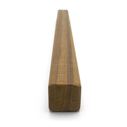 Thermo-Radiata Pine 1x1 Trim piece in an end view, showing the square cross-section and grain running into the distance
