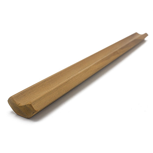 Thermo-Radiata Pine 1x2 Inside Corner Trim piece at an angle, showing a long brown strip with a concave groove on top